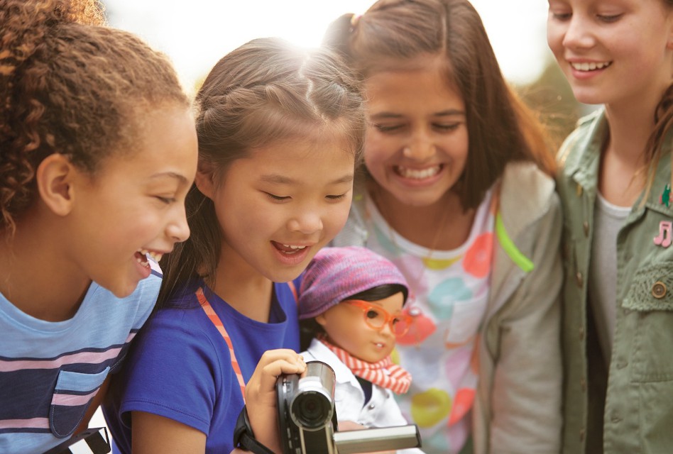 American Girl's Z Yang doll surrounded by real American girls.