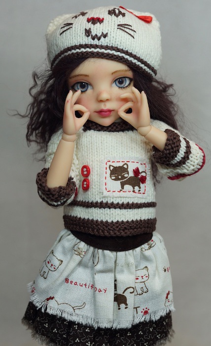 This doll's hands sign "kitty cat" in ASL.