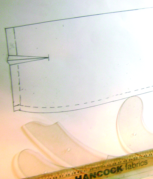 Refining the skirt pattern. The drafting tools shown here make it easier to get a perfect line.